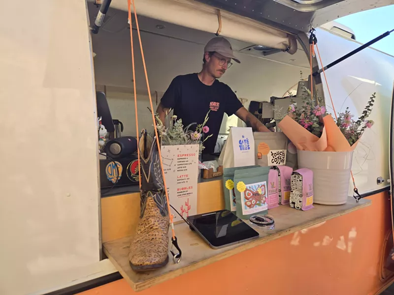 Image: a man standing behind a counter