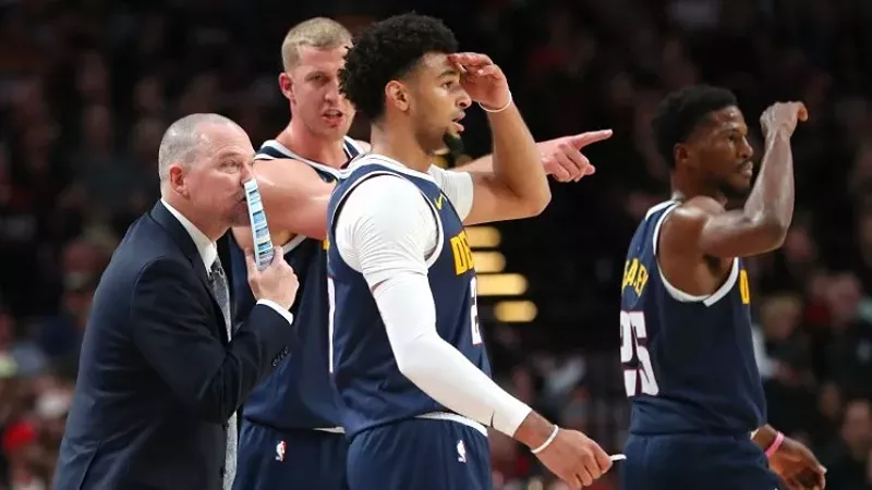 Image: Denver Nuggets coach Michael Malone and players Mason Plumlee, Jamal Murray and Malik Beasley (from left) on the lookout during the Nuggets' win over the Portland Trail Blazers on October 23.