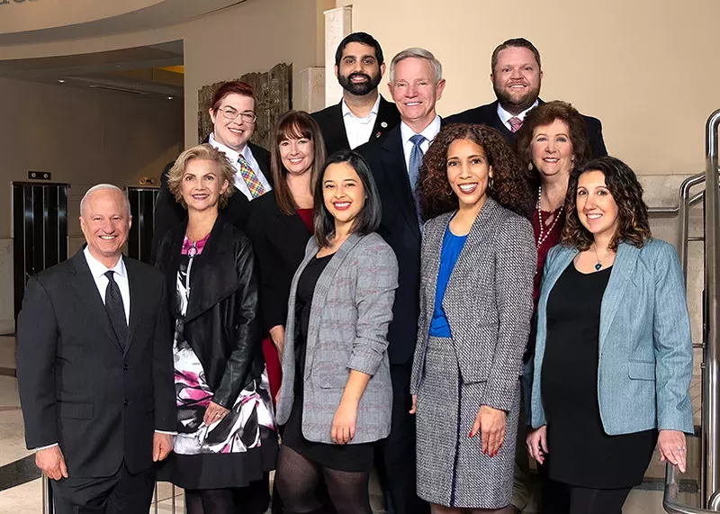 Image: Mayor Mike Coffman (left) and members of the Aurora City Council.