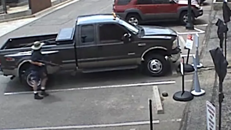 Image: Gunman Ronald Troyke holding an automatic weapon after shooting and killing police officer Gordon Beesley, as seen in a video just released by the Arvada Police Department.