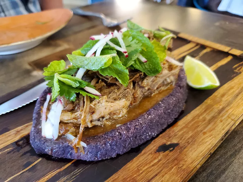 Image: Cochinita is served in a blue corn masa boat.