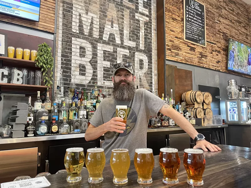 Image: Little Dry Creek Brewery's head brewer Ty Nash standing at the bar.