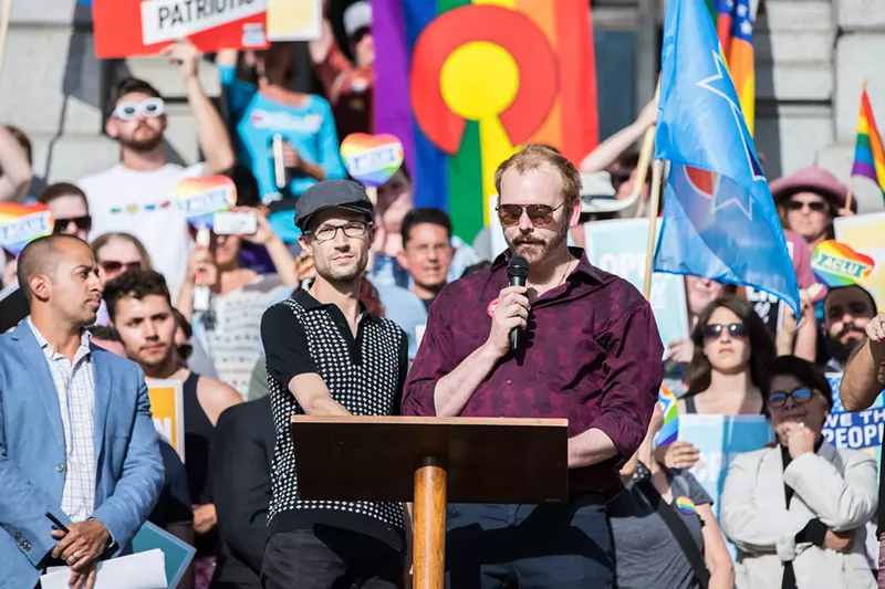 Image: Dave Mullins, left, and Charlie Craig speak at a rally in response to the Masterpiece Cakeshop Supreme Court ruling on June 4, 2018.