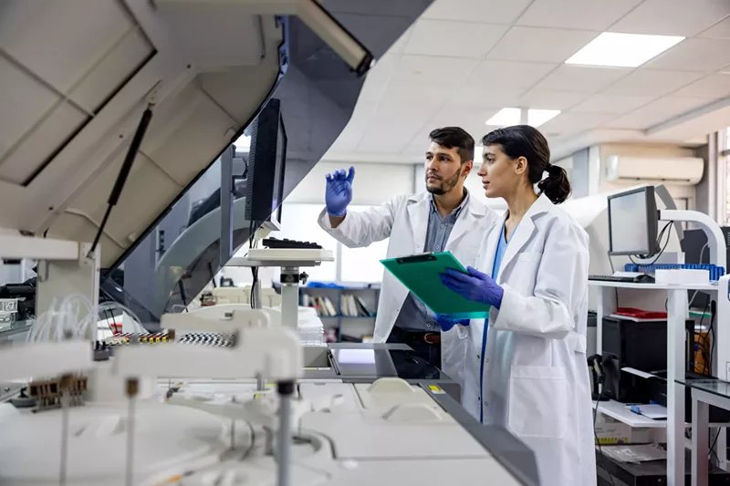 Image: man and woman in lab coats