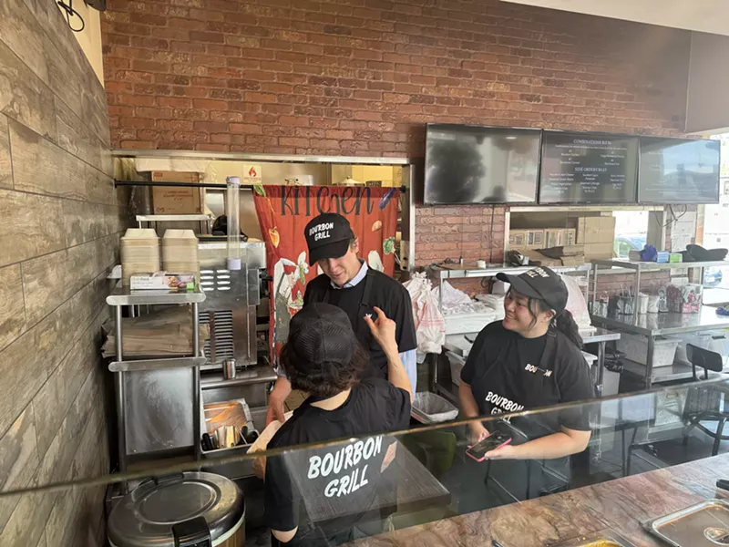 Image: Mayor Mike Johnson scooping lunch with Lien Vo, who owns Bourbon Grill, and her daughter Kim.