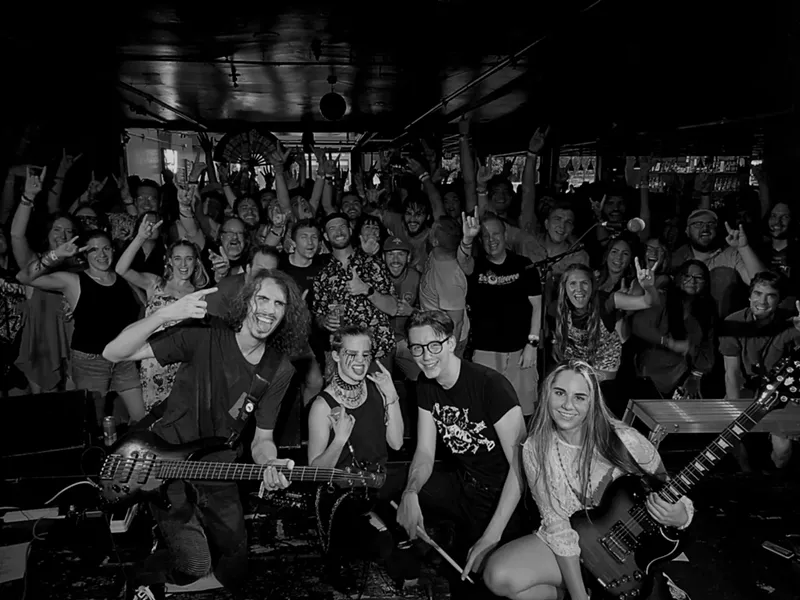 Image: rock band poses with audience