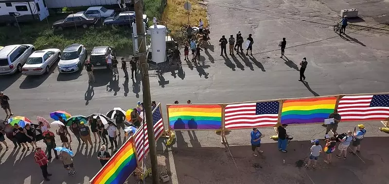 Image: Members of the Parasol Patrol block children and families from the sight of protesters outside Drag for All Ages at Mile High Comics on August 24.