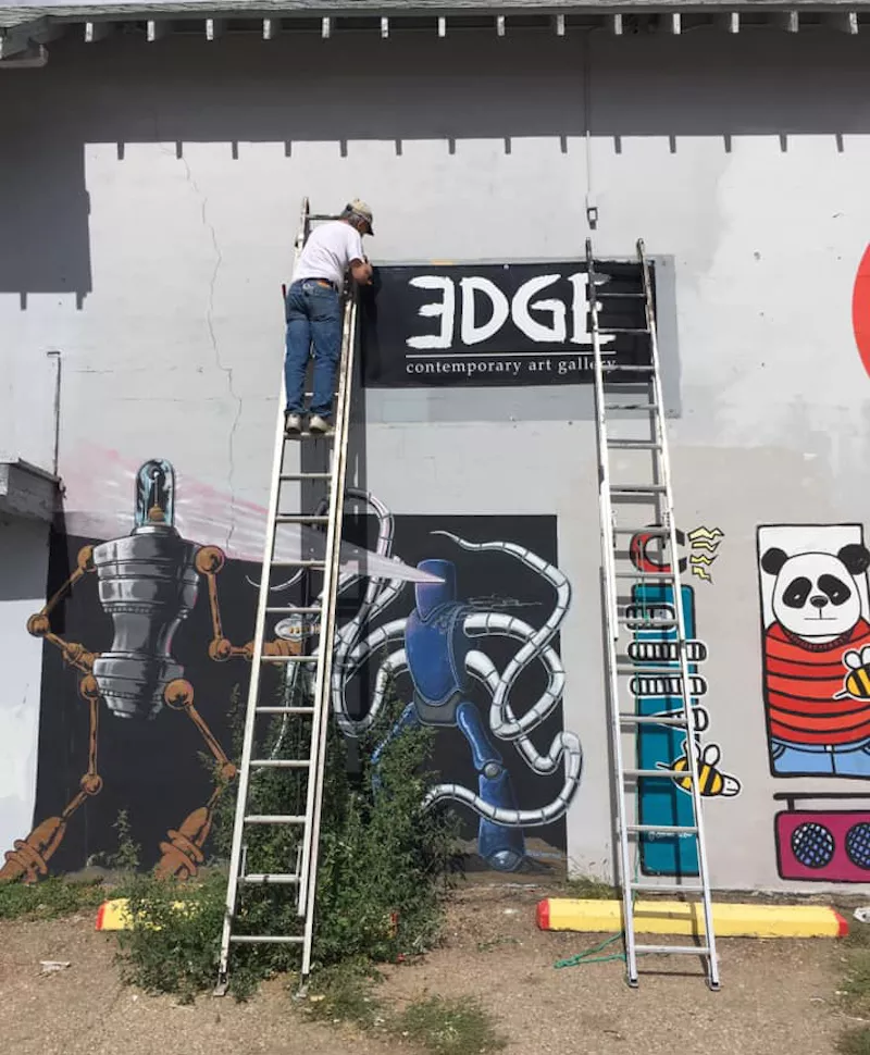 Image: Edge member Stephen Shugart hangs the Edge sign at new digs in Pasternack's Art Hub.