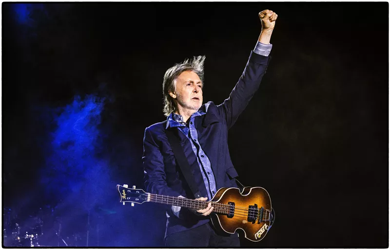 Image: Paul McCartney with a guitar on stage