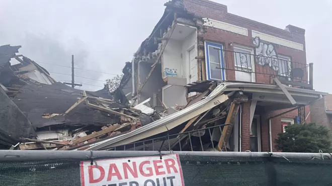 Destroyed house with warning signs