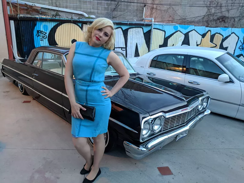Image: Betty Garcia spotted at the Viva La Sirena fashion show at Museo de las Americas April 19. (Cars by Compas Colorado Car Clubs.)