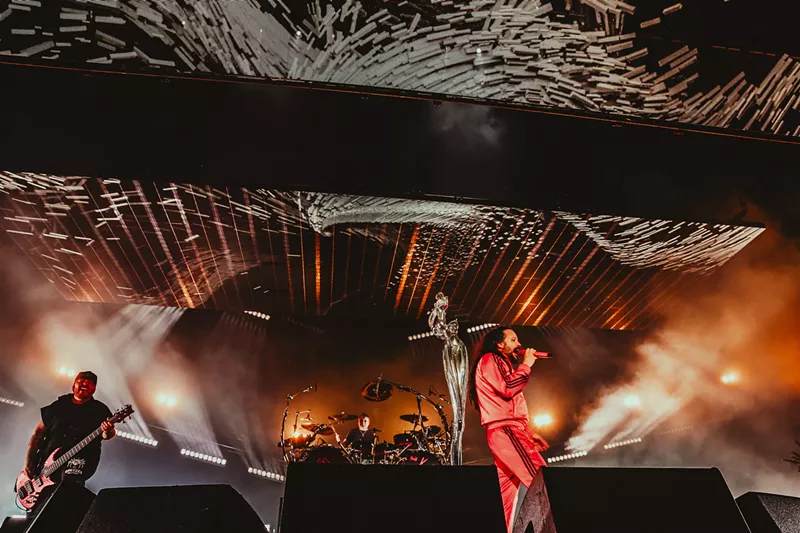 Image: a group of people standing on top of a stage