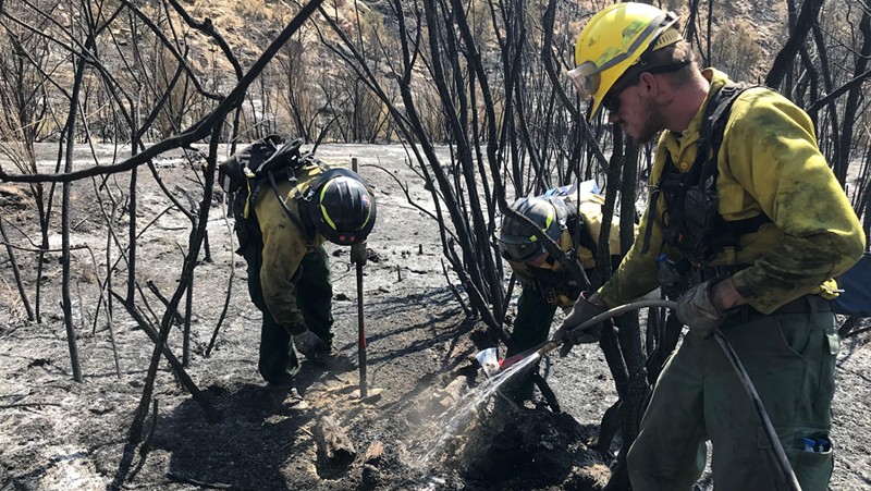 Firefighters mopping up hot spots at the Pine Gulch fire earlier this week.