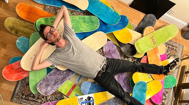 a man lying on top of skateboard decks