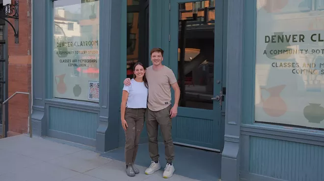 two people stand in front of a building