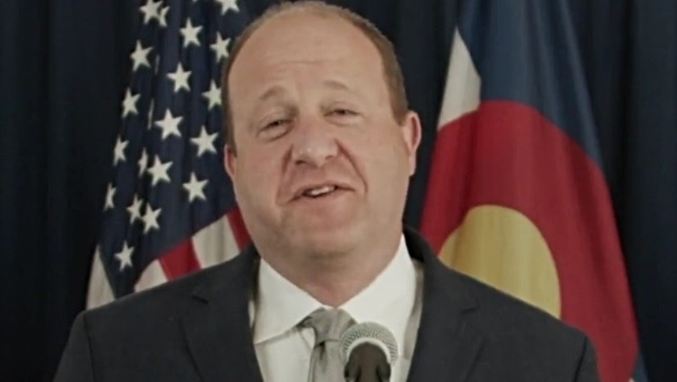 Governor Jared Polis unmasked at a May 14 press conference.