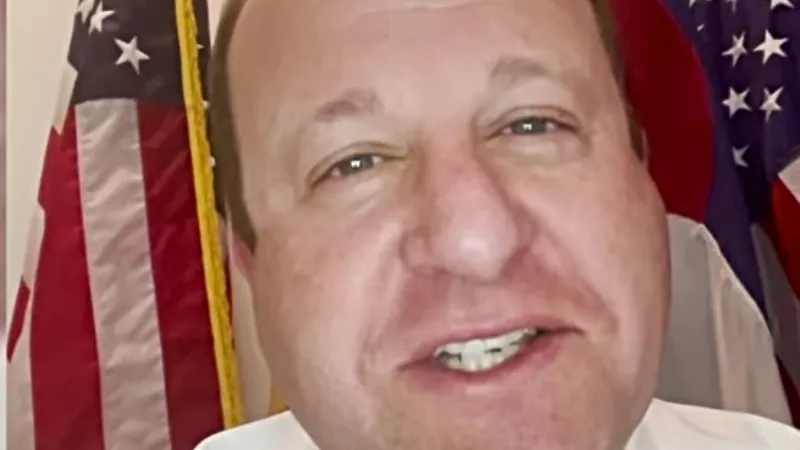 Image: Governor Jared Polis as seen in a recent video in which he challenged Oregon's governor to a bet (of a six-pack) that the Denver Nuggets would defeat the Portland Trail Blazers in their first-round NBA playoff game.