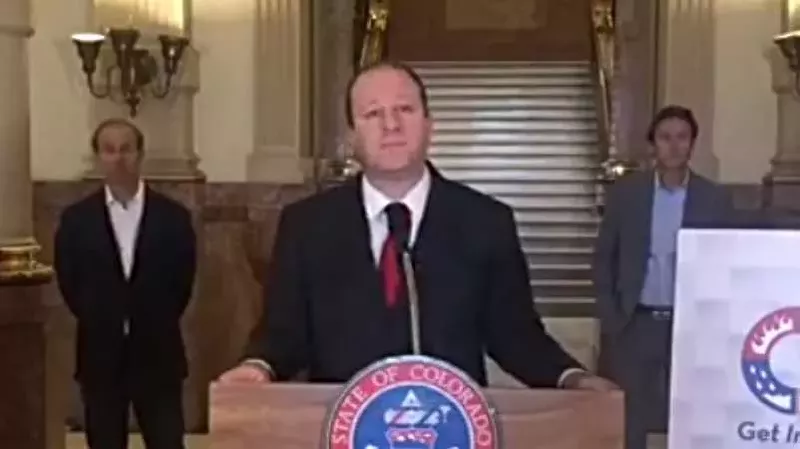 Image: Colorado Governor Jared Polis speaking today at the State Capitol shortly after it was closed to the general public.