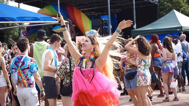 A person in a pink dress dances