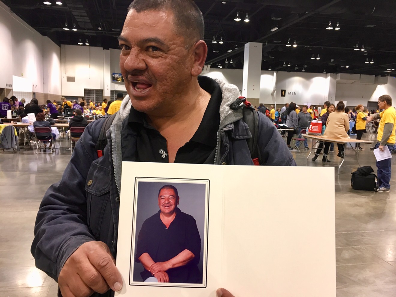 Gary Pacheco shows off a portrait that was taken of him at Project Homeless Connect on November 15.