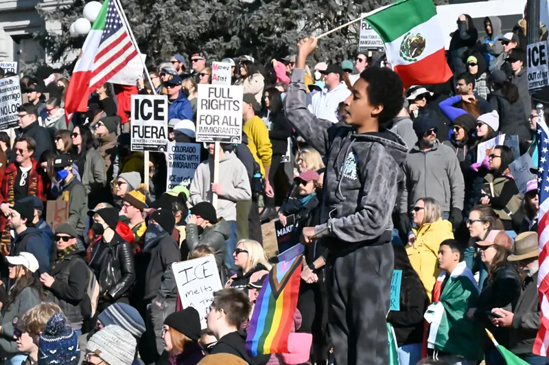 Image: A boy waives a flag among protesters.