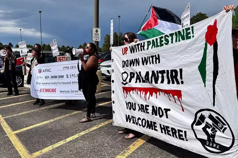 Image: Protesters hold signs