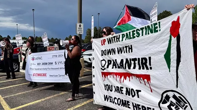 Protesters hold signs