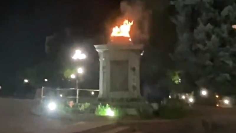 A screen capture from a Twitter video showing the burning statue base outside the Colorado State Capitol late on June 26.
