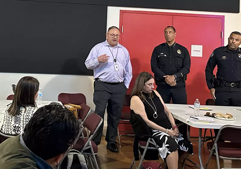 Image: Denver law enforcement officials talk during public meeting