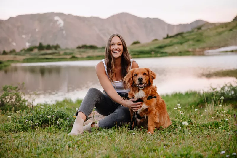 Image: woman sitting with dog outside