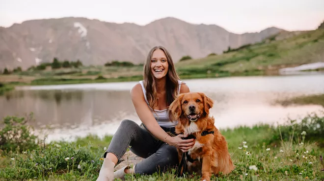 woman sitting with dog outside