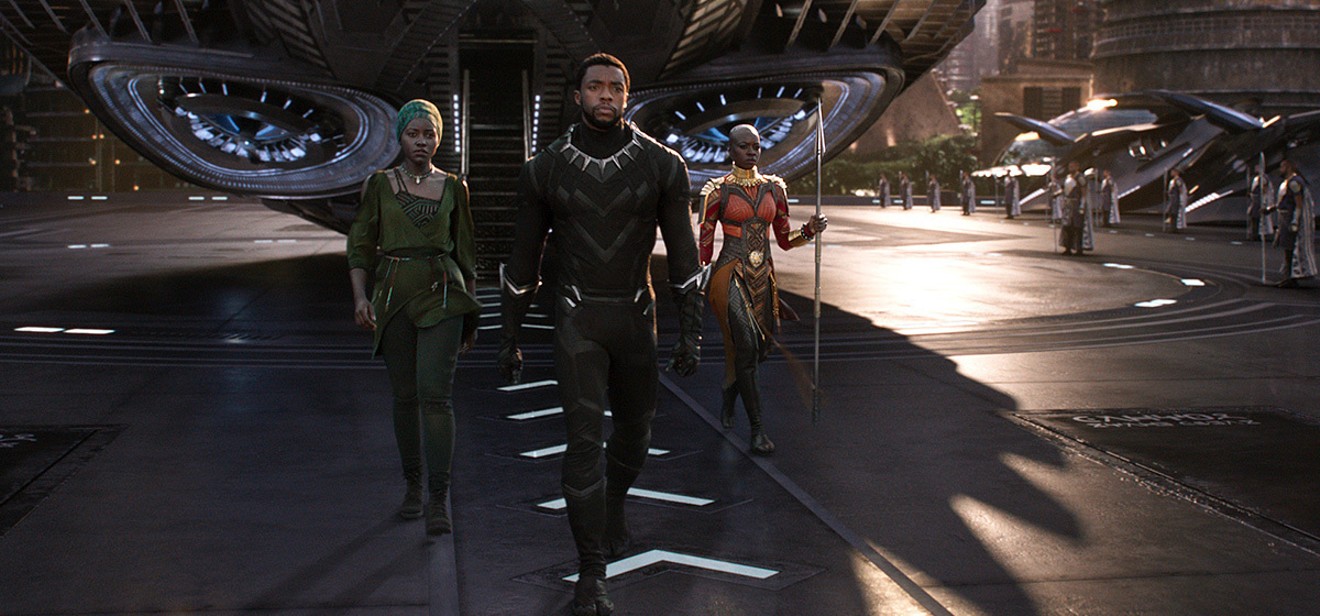 T'Challa/Black Panther, King of Wakanda, along with Nakia (left) and Okoye (right).