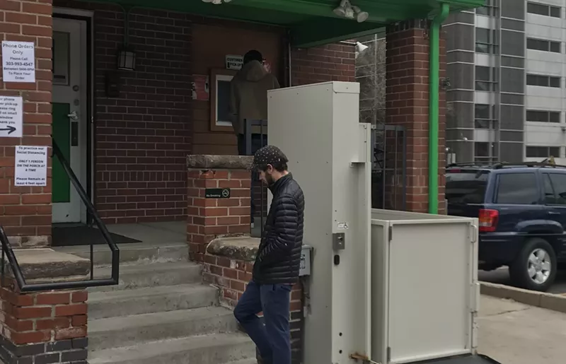 Image: Customers wait to pick up marijuana from a to-go window outside of Higher Grade dispensary in Denver.