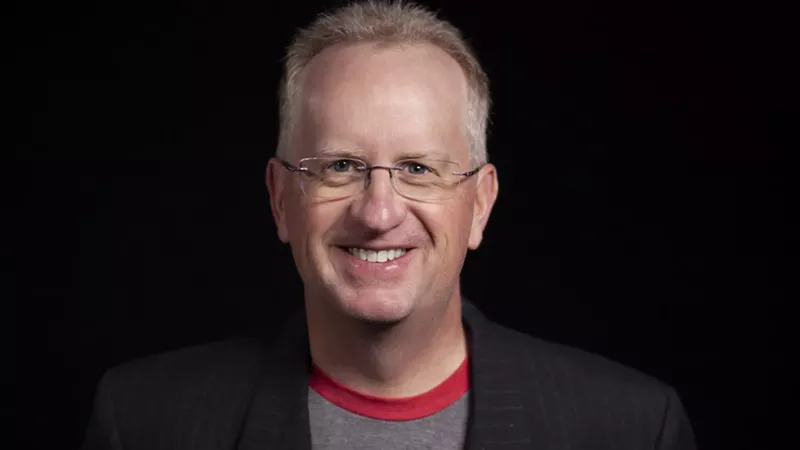 Image: man in glasses and t-shirt under blazer