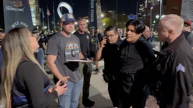 Image: vendors talking to police