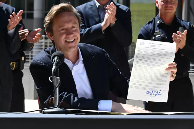 Image: A man smiles with paper.