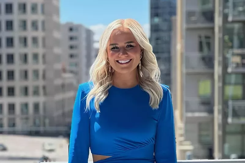 Image: woman in blue before skyline