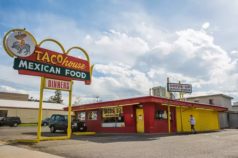 Image: small red and yellow building with a retro sign