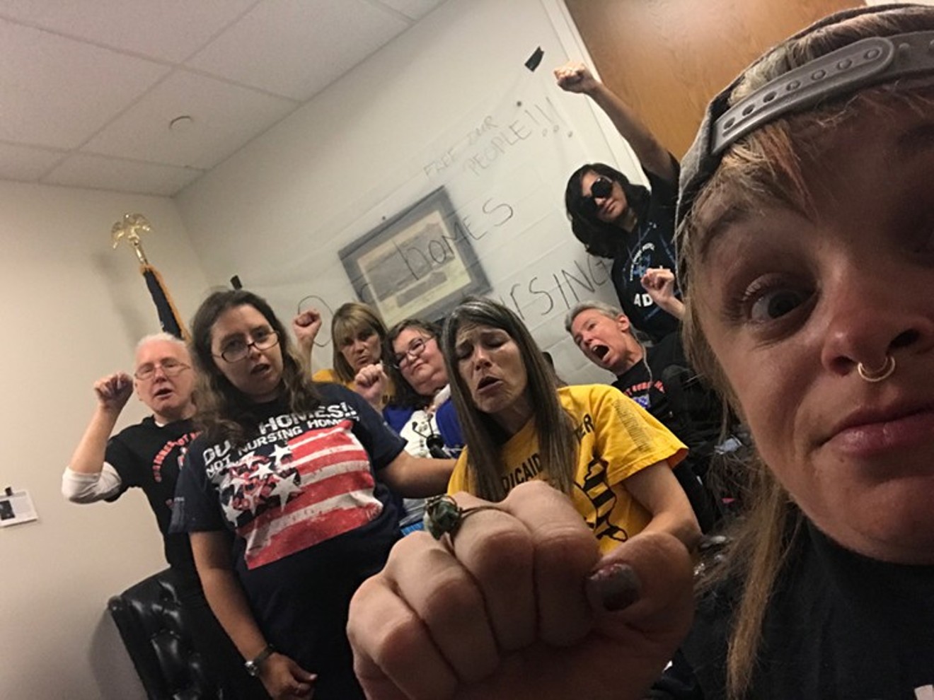Kalyn Heffernan (right) and other ADAPT protesters at Cory Gardner's office.