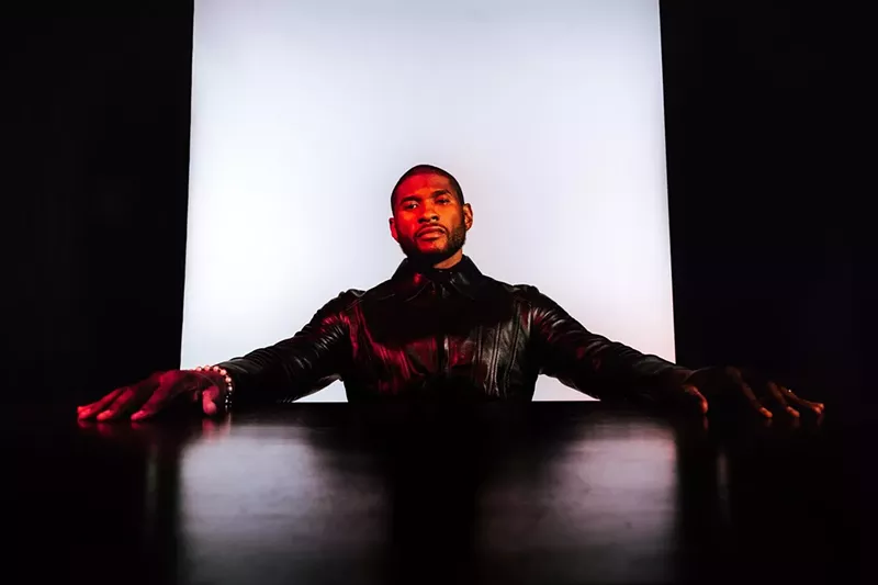 Image: usher, in leather with arms out