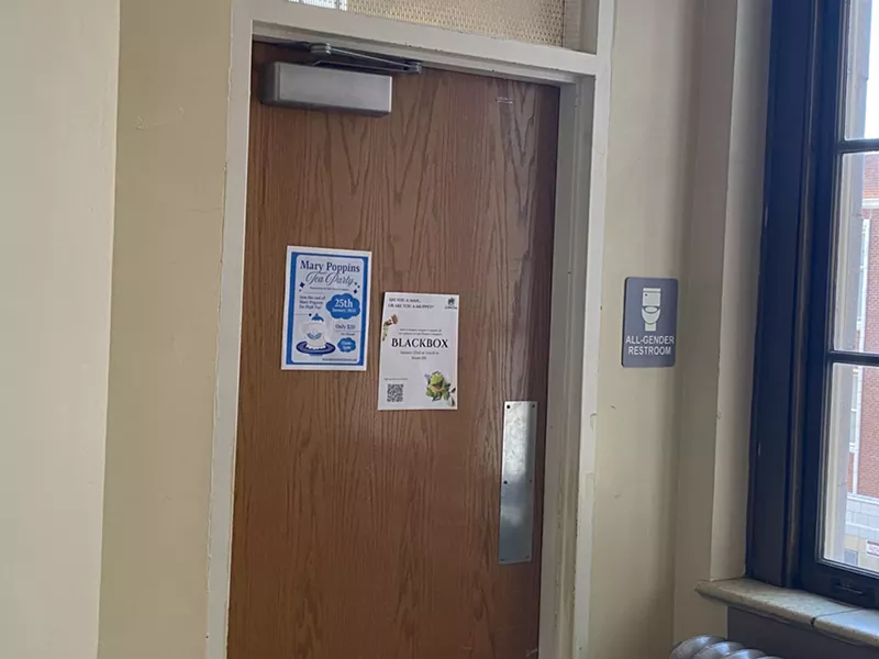 Image: all-gender bathroom door at high school