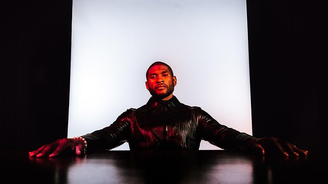 usher, in leather with arms out