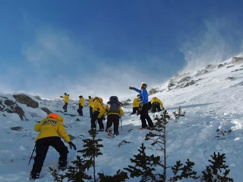 Image: Dale Atkins (in blue) directing team members during an avalanche rescue training.