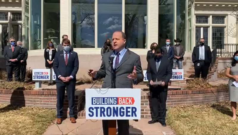 Image: Governor Jared Polis (pictured at a March meeting with restaurant owners and government officials) is turning over COVID restrictions to local governments.