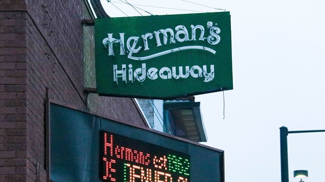 green sign of Herman's, a Denver music venue.