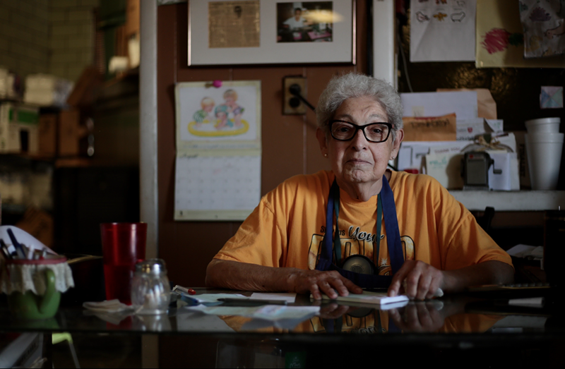 Image: older woman at restaurant table