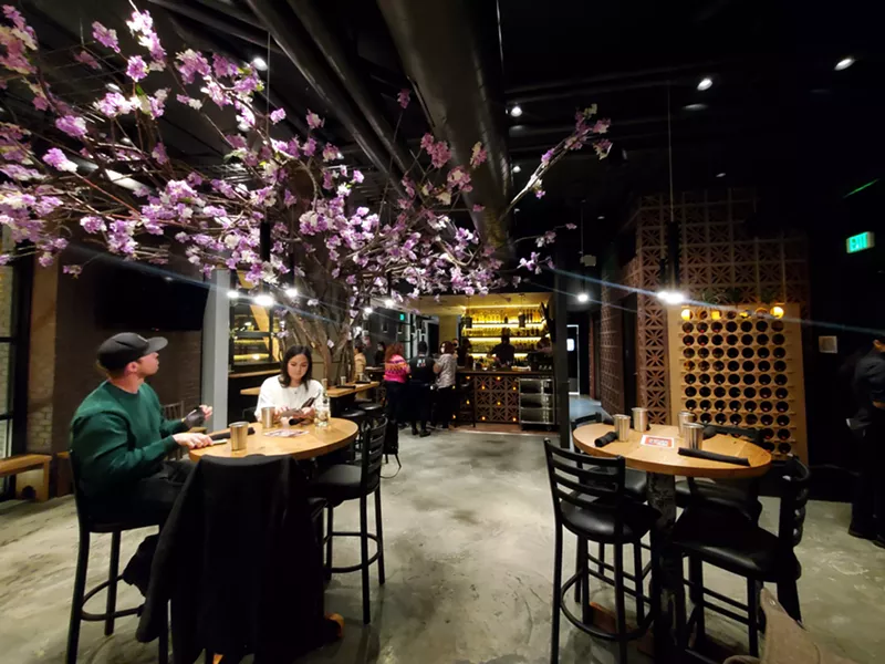 Image: A tree with lavender-hued flowers is the centerpiece at Cantina Loca.