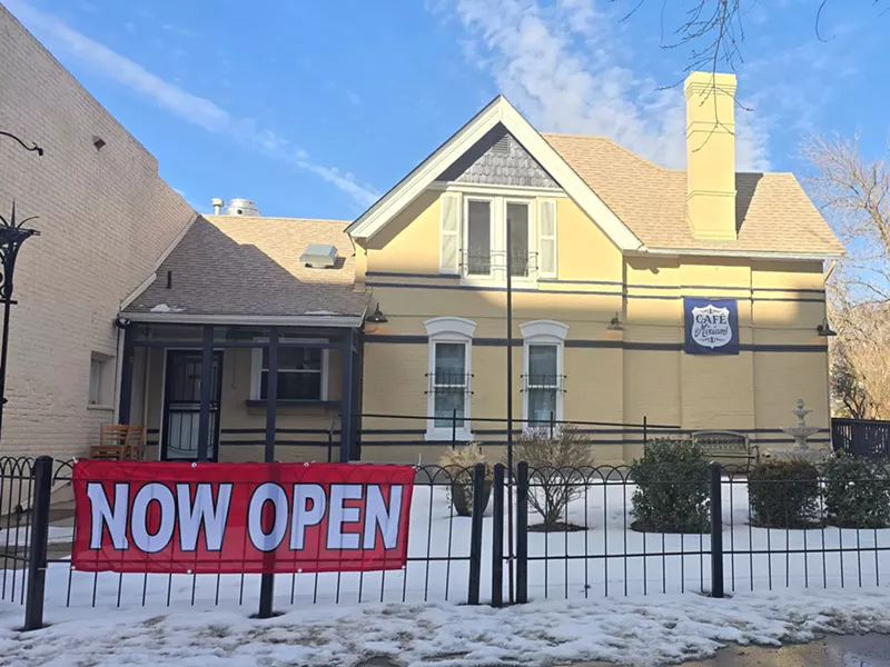 Image: "now open" sign in front of a building