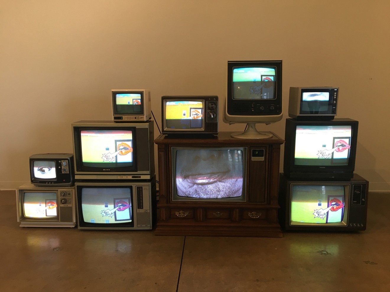 Brian Fouhy's installation of found TV sets and videos in Delirium at RedLine.