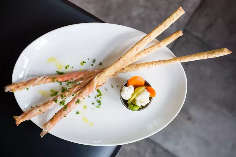 Image: Man could live on these breadsticks alone: The Bindery’s housemade grissini are wrapped in prosciutto.